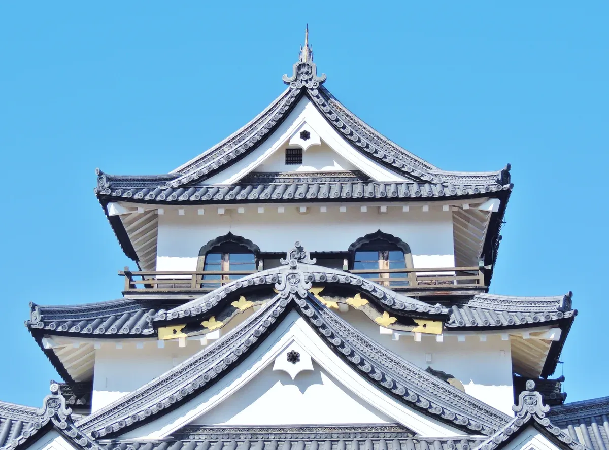 The keep of Hikone Castle by Lake Biwa against a blue sky on a day trip from Kyoto